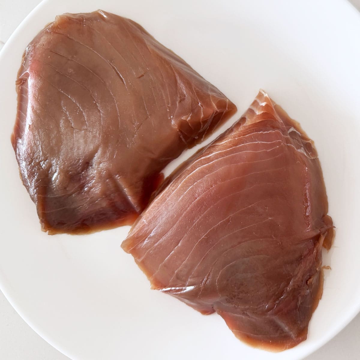 Two smaller tuna steaks from Fulton Fish Market.