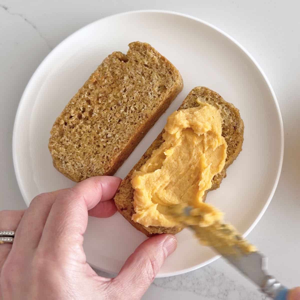 Spreading leftover sauce on almond flour bread.