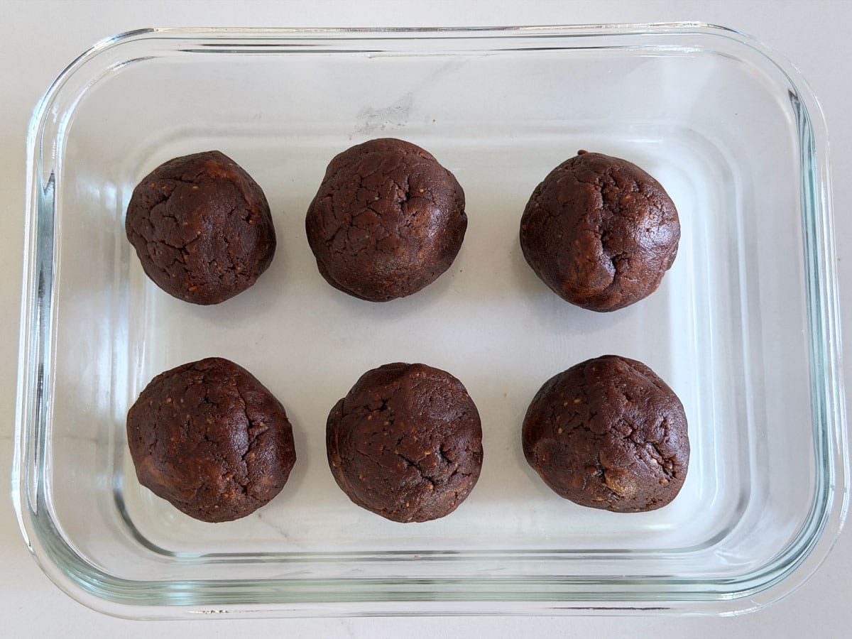The fat bombs are stored in a glass container.