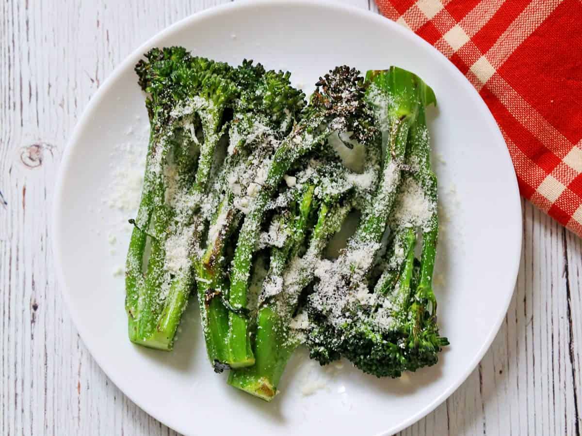 Grilled broccolini is topped with Parmesan.