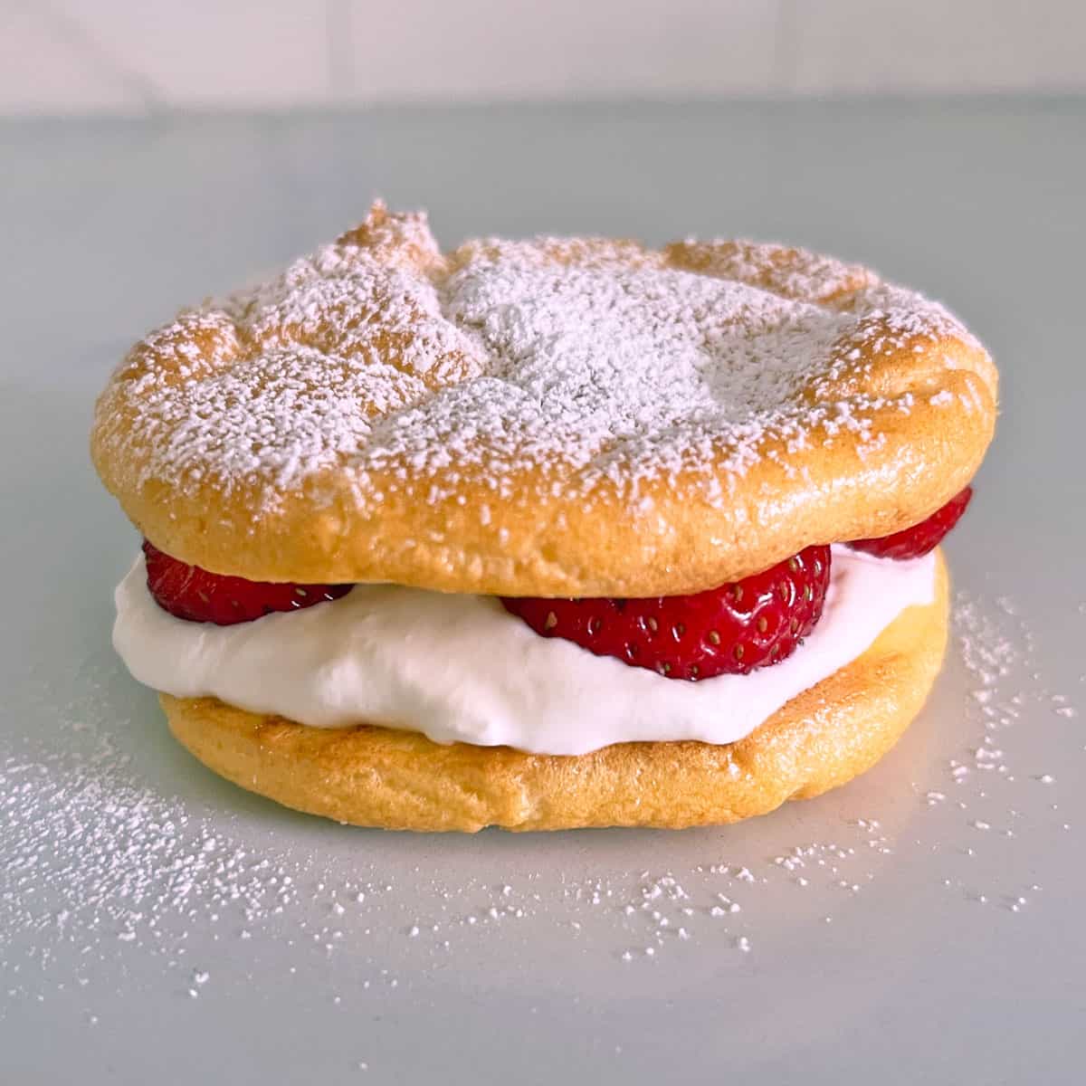 Cloud bread is filled with whipped cream and strawberries.