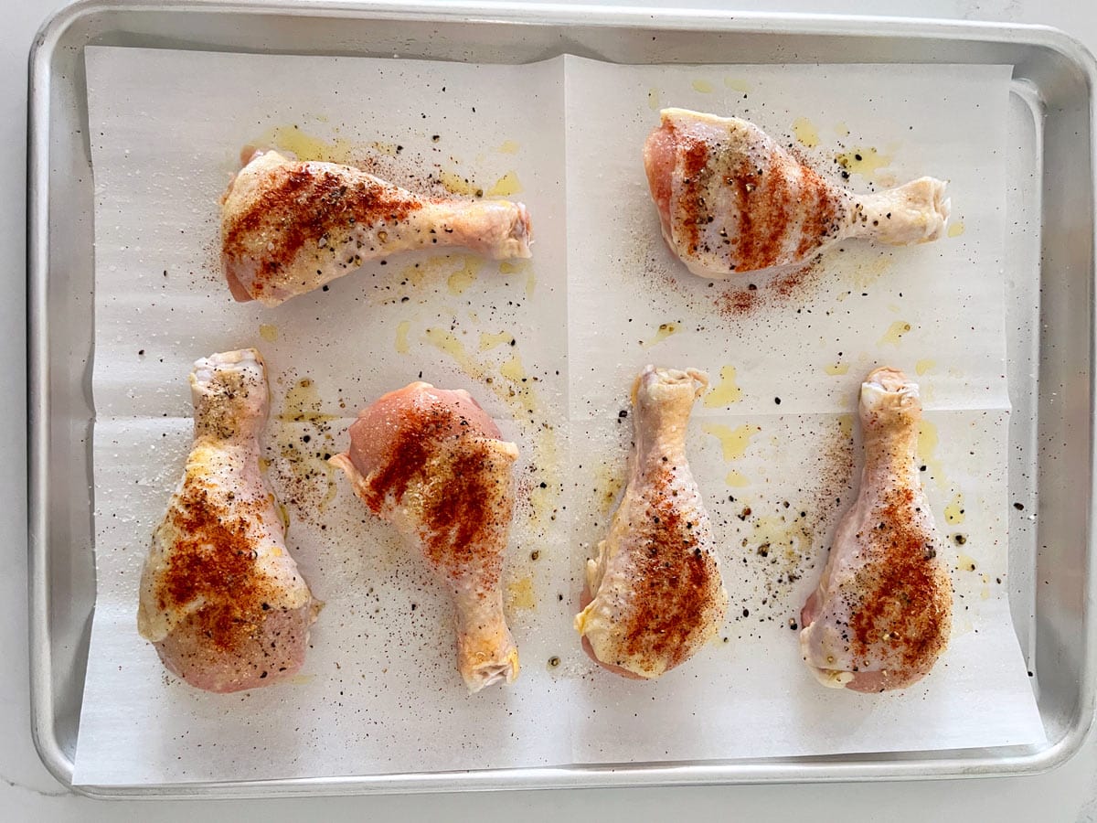 Drumsticks arranged on a sheet pan.
