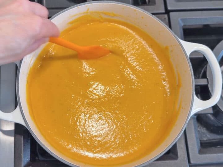 Mixing in heavy cream and Parmesan.