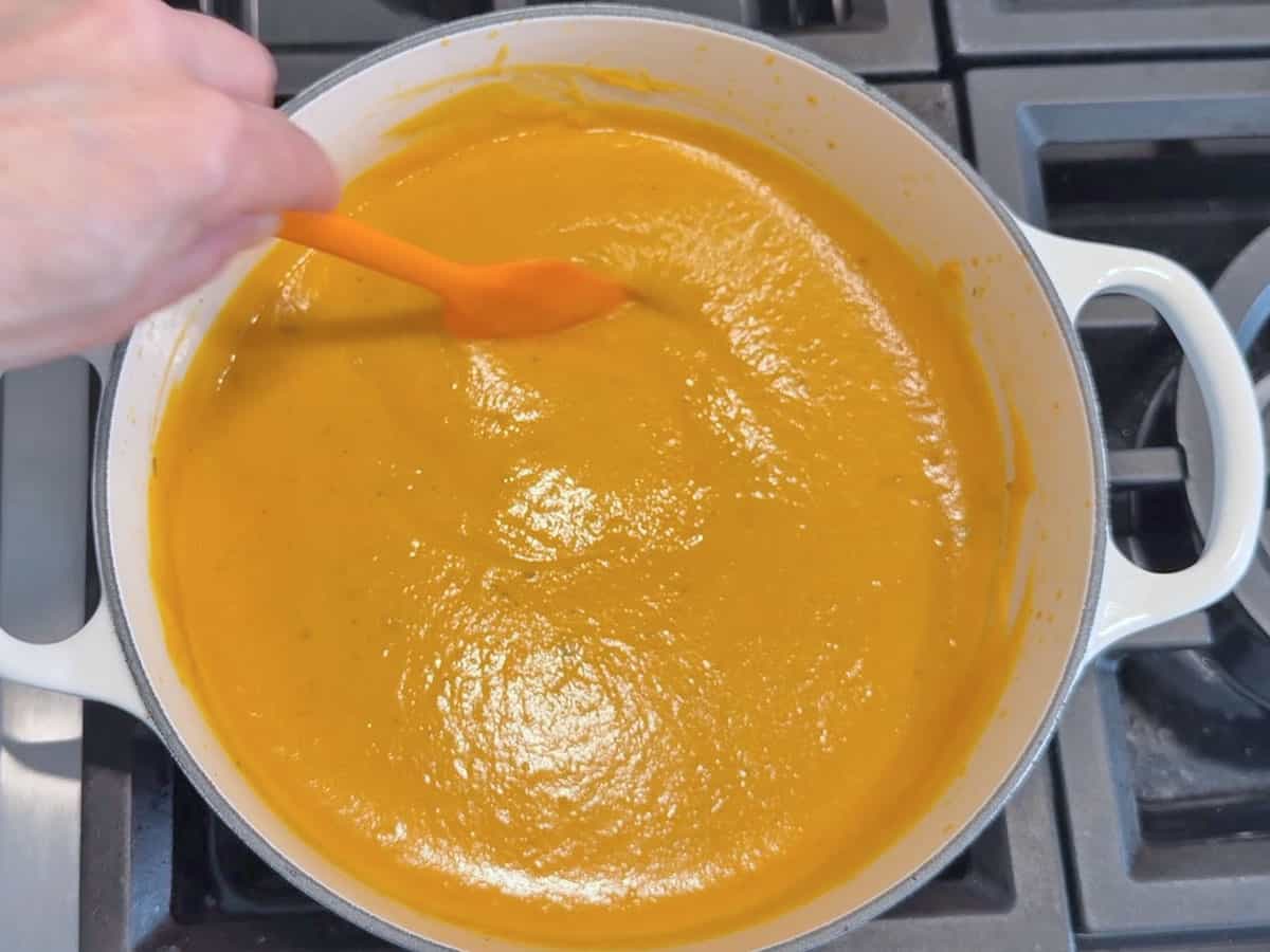 Mixing in heavy cream and Parmesan.