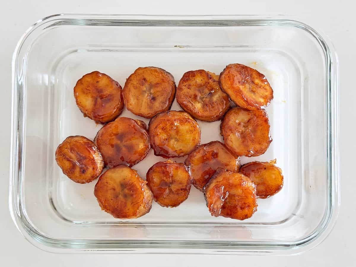 Fried bananas leftovers are stored in a glass container.