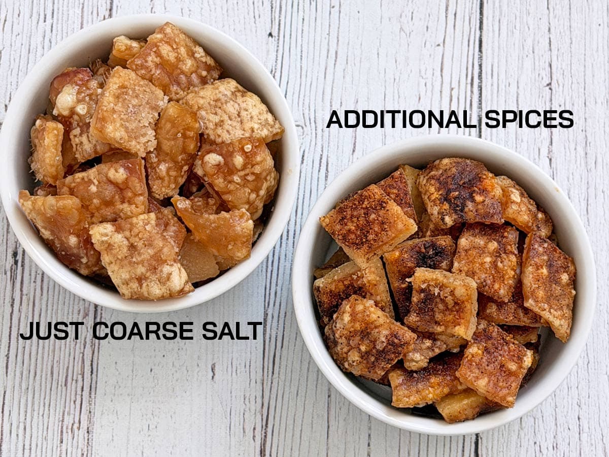 Two bowls of pork rinds, one with just salt and one with more spices.
