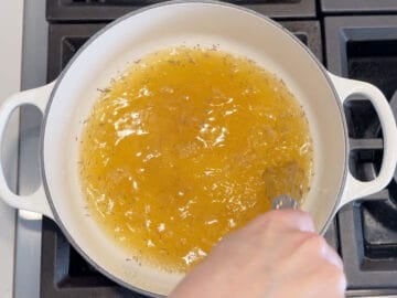 Mixing chicken broth and spices.
