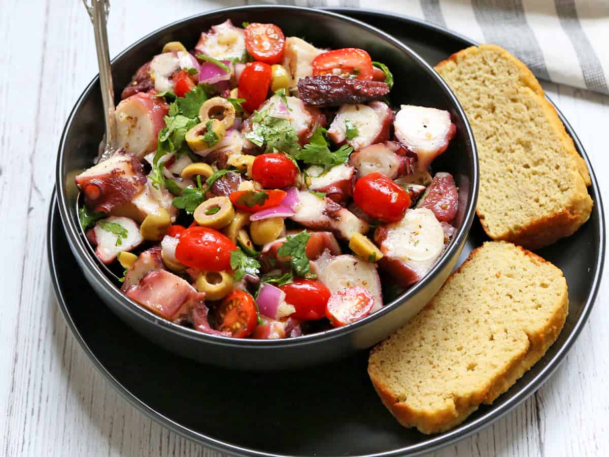 Octopus salad is served with almond flour bread.
