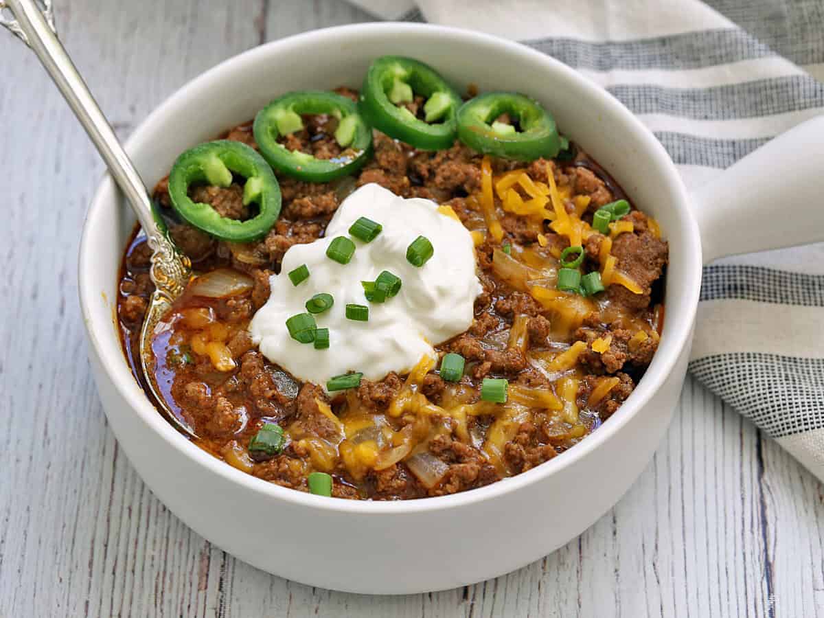 Texas-style chili is served in a white bowl.