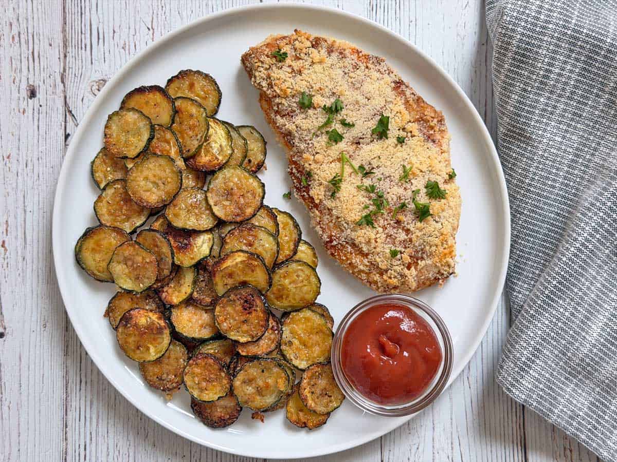 Zucchini chips are served with Parmesan-crusted chicken.