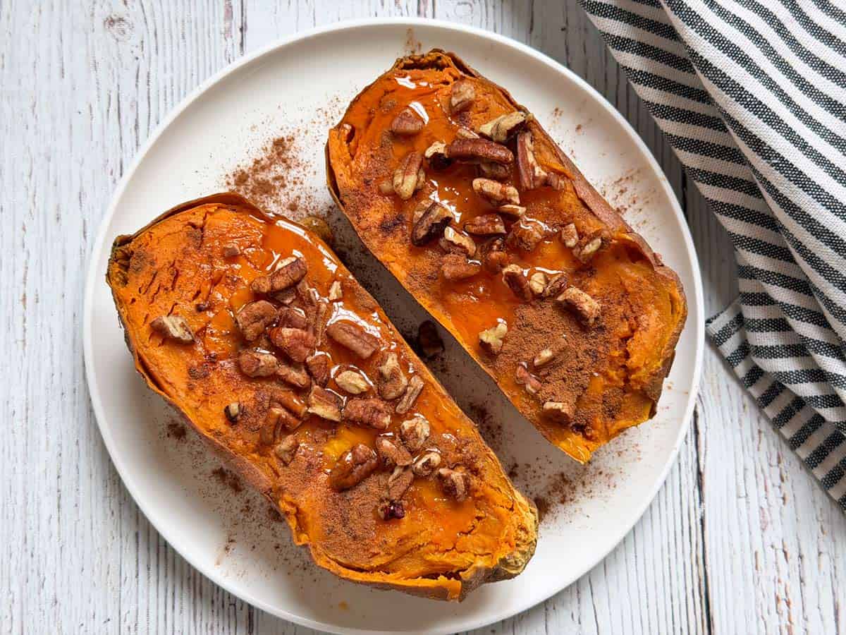 A sweet version of microwave sweet potato with maple syrup, cinnamon, and nuts.