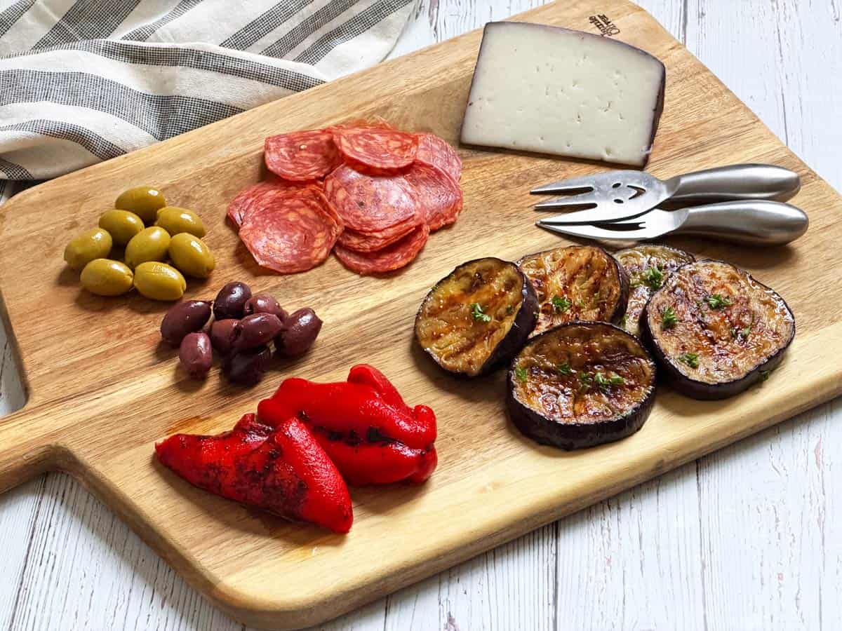 Grilled eggplant leftovers are served as part of a antipasti platter.